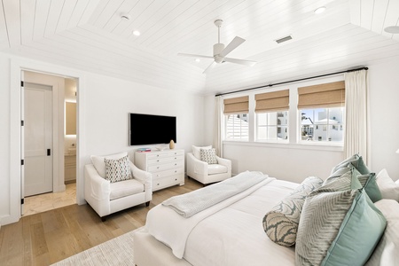 Relax in this serene bedroom with plush seating, crisp linens, and coastal touches that create your perfect retreat.
