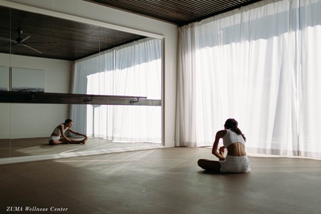 Find your zen in this serene wellness studio with floor-to-ceiling windows and mirrored walls for your perfect yoga or meditation retreat.