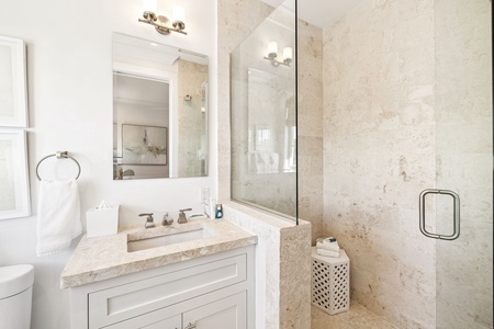 Step into your spa-like bathroom with luxurious marble surfaces, a spacious glass shower, and elegant fixtures that create the perfect retreat.
