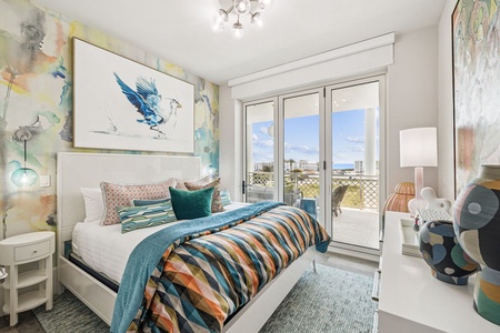Wake up in this vibrant bedroom where colorful artwork and ocean breezes create your perfect coastal retreat.