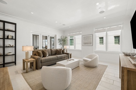 Settle into this bright, airy living room where plush seating and soft natural light create the perfect space for your morning coffee or evening unwind.