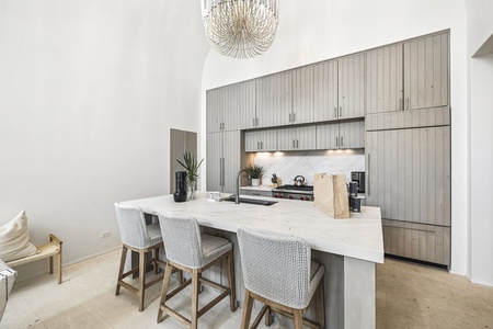 Your chef-ready kitchen features soaring ceilings, gleaming marble countertops, and top-tier appliances—perfect for gathering, cooking, and making vacation memories together.