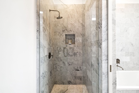 Step into your luxurious marble shower sanctuary, where rainfall flows and elegant stone surrounds create your perfect daily retreat.