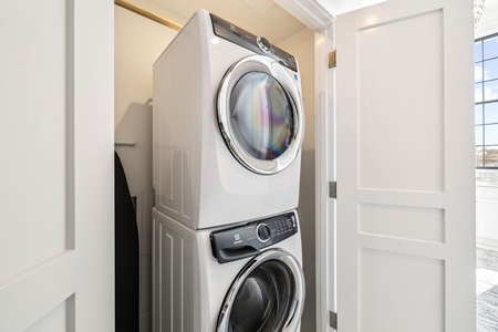 Enjoy the convenience of your own stacked washer and dryer, tucked neatly in a bright, organized laundry closet for effortless cleaning during your stay.