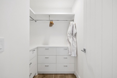 Your private walk-in closet offers thoughtful storage with built-in drawers and open hanging space, keeping your belongings organized and within easy reach throughout your stay.