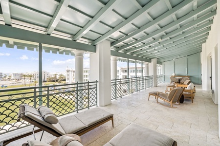 Relax on your expansive covered terrace with elegant furnishings and stunning views of the surrounding area.