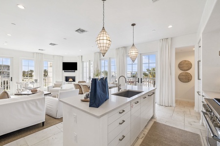 Cook in your bright, open kitchen while enjoying stunning coastal views through floor-to-ceiling windows.