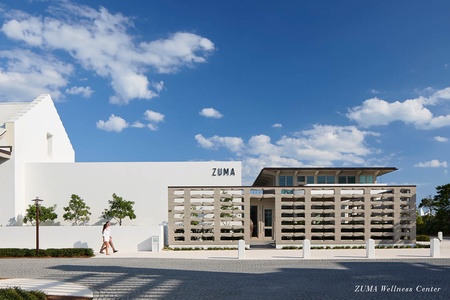 Modern wellness center with striking architectural design featuring clean white facades and decorative screening elements.