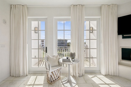 Relax in your peaceful reading nook with stunning city views through floor-to-ceiling French doors that flood your space with natural light.