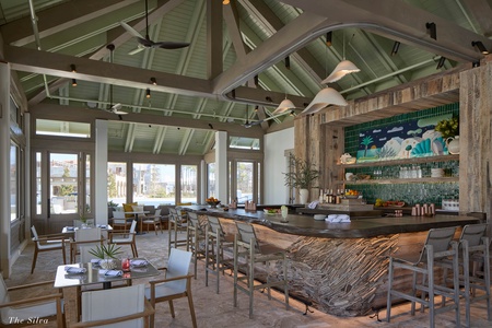 Gather at this stunning beachside restaurant where rustic wood meets vibrant tiles, creating the perfect backdrop for your coastal dining experience.