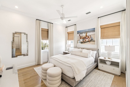 Unwind in your serene bedroom with plush bedding, natural light, and coastal artwork creating the perfect retreat.
