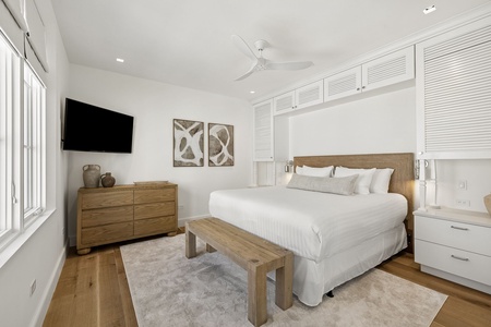 Unwind in your serene bedroom with plush linens, coastal décor, and modern comforts like a flat-screen TV. Bright, airy design and ample storage ensure your restful escape.
