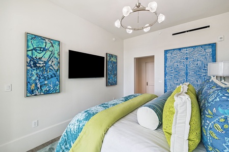 Drift into restful sleep surrounded by vibrant ocean-inspired artwork and contemporary comfort in your stylish bedroom retreat.