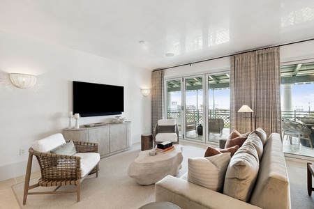 Sink into plush seating while enjoying your favorite shows on the large TV, then step onto your private balcony for stunning views.