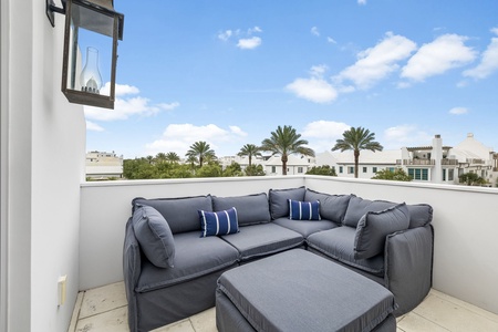 Sink into plush outdoor seating on your private rooftop terrace, where palm-lined views and endless blue skies create the perfect backdrop for morning coffee or evening relaxation.