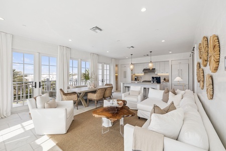 Relax in your bright, airy living space where coastal comfort meets modern elegance. Natural light floods through floor-to-ceiling windows.