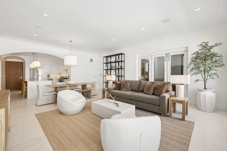 Sink into plush seating in your light-filled living space, where modern elegance meets coastal comfort, perfect for unwinding after exploring or gathering with loved ones.