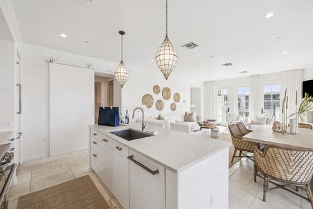 Cook your favorite meals in this bright, open kitchen featuring pendant lights and flowing seamlessly into your living space.