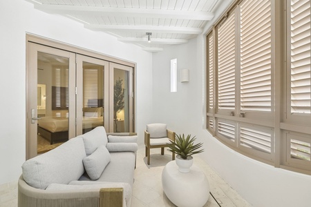 Step into your own tranquil retreat, where soft seating and serene white tones invite you to unwind in complete comfort and style.