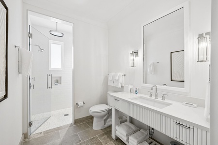 Refresh in your private sanctuary with a spacious walk-in shower, elegant vanity, and plush towels ready for your arrival.