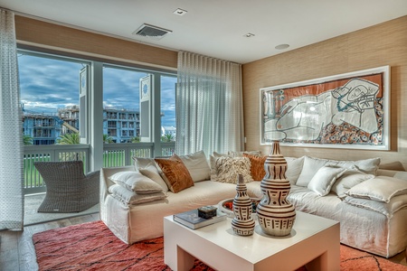 Sink into plush cushions and let warm natural light wash over you. Your modern living room opens to a private balcony, blending comfort with contemporary style and offering peaceful views.