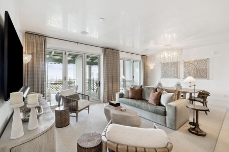 Sink into plush seating while admiring city views through floor-to-ceiling windows. Elegant furnishings and soft lighting create your perfect retreat.