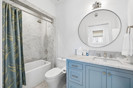 This bright, spa-like bathroom offers a sleek marble vanity, soaking tub, and soothing shower—a tranquil retreat for your morning and evening routines.