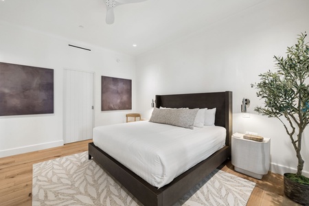 Slip into crisp white linens and sink into your plush king bed after a day of exploring. Modern artwork and a cozy reading chair create your serene sanctuary.