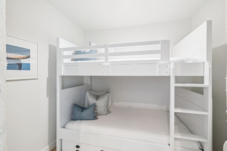 Your kids will love these cozy built-in bunk beds with soft linens and cheerful coastal touches for the perfect night's sleep.