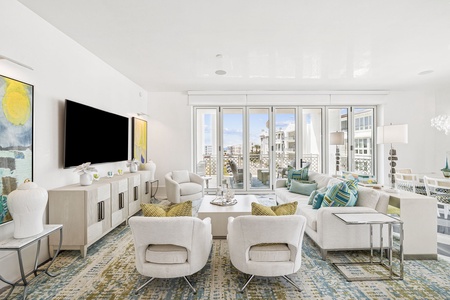 Settle into your stylish living room featuring plush seating and floor-to-ceiling windows showcasing stunning city views from your urban retreat.