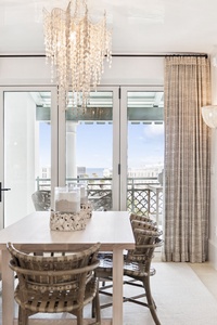 Your elegant dining space features stunning chandelier lighting and opens to a private balcony with city views.