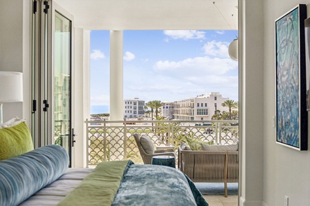 Wake up to stunning views from your private balcony overlooking tropical palms and coastal architecture, creating the perfect morning retreat.