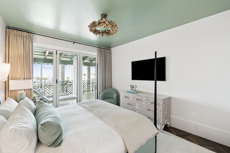 Rest peacefully in your serene bedroom featuring elegant sage tones, plush bedding, and balcony doors opening to refreshing outdoor views.