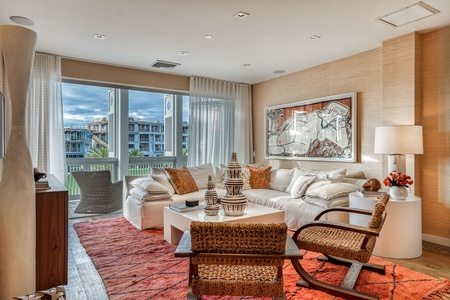 Sink into the plush seating and let the natural light wash over you in this thoughtfully designed living space. Warm textures and curated details create your perfect retreat.