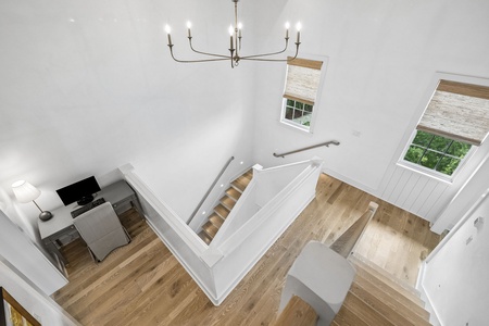 Soaring ceilings and an elegant chandelier create a bright, airy space where your vacation feels elevated. Natural light pours through skylights, warming the wood floors beneath your feet.