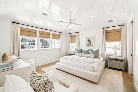 Drift off in this serene bedroom where soft linens meet coastal charm. Natural light floods your space through bamboo shades.