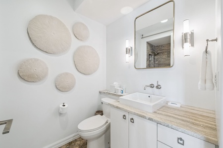 Step into your serene spa-like bathroom with elegant coastal artwork, modern fixtures, and luxurious marble finishes for ultimate relaxation.