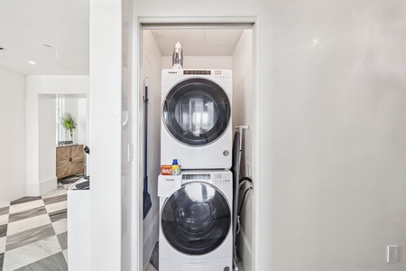 Your in-unit laundry closet features a sleek stacked washer and dryer, making it easy to keep your clothes fresh throughout your stay.