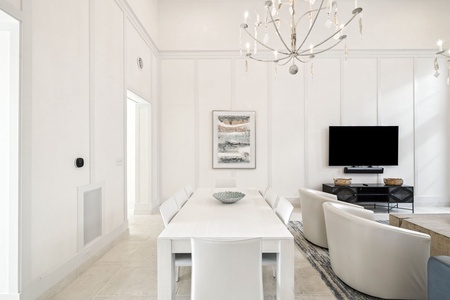 Relax in your bright, modern space with a stylish dining table and cozy living area perfect for unwinding after exploring.