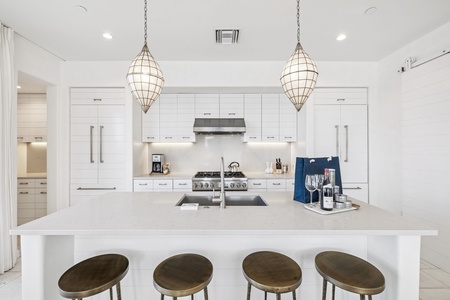 Your gourmet kitchen awaits with gleaming countertops, professional-grade appliances, and stylish pendant lighting perfect for culinary adventures.