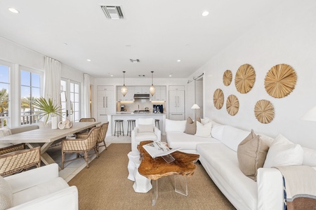 Sink into this bright, airy living space where natural textures meet modern comfort. Your coastal retreat features an open kitchen perfect for gathering.