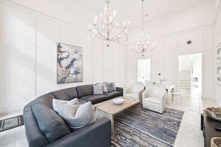 Unwind in your elegant living space where plush seating and sparkling chandeliers create the perfect atmosphere for relaxation.