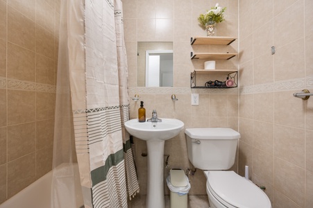Your private bathroom features a refreshing shower, thoughtful storage shelves, and charming touches that make your morning routine feel special.