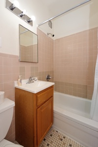 Your private bathroom features warm tile details, quality fixtures, and everything needed for a refreshing start to your day.