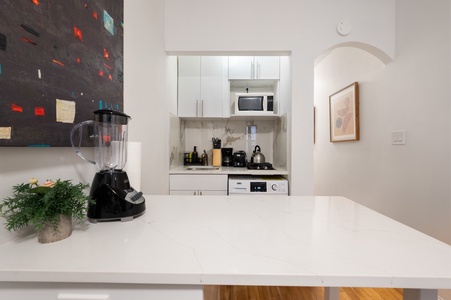 Your sleek kitchenette features modern appliances and marble countertops, perfect for preparing meals in style.