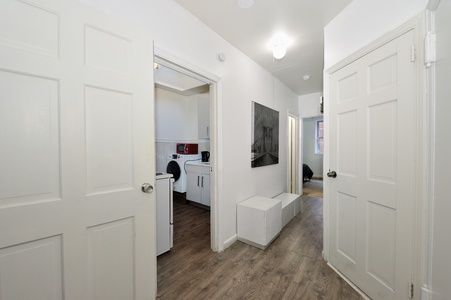 Your bright hallway leads to convenient in-unit laundry facilities, making your stay effortlessly comfortable with modern amenities.