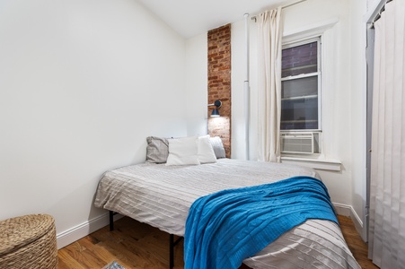 Sink into crisp linens and rest against charming exposed brick in your peaceful bedroom retreat with convenient air conditioning.