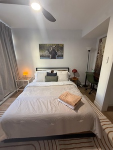 Unwind in your cozy bedroom featuring crisp linens, thoughtful touches, and warm lighting that creates the perfect retreat after exploring.