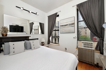 Your stylish bedroom features crisp white linens, modern lighting, and a smart TV for cozy evenings in.