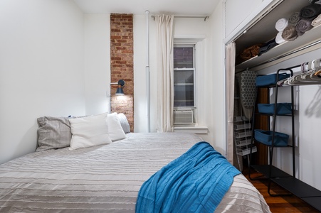 Rest peacefully in your cozy bedroom featuring exposed brick, crisp linens, and thoughtful storage for all your belongings.